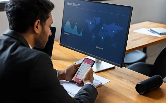 Fintech professional analyzes import business data on a world map, using mobile banking.