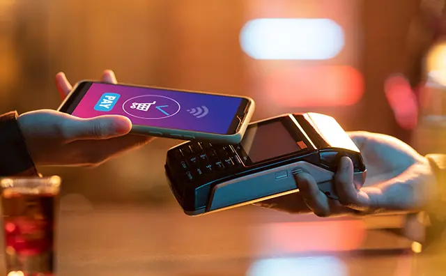 Contactless phone payment at a POS terminal showcases fintech and mobile banking.