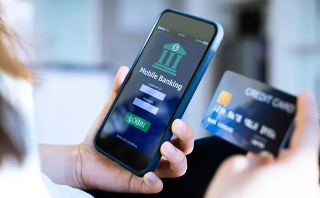 Mobile banking: A person uses a credit card to log into a banking app.