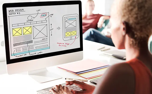 Web design sketch on a computer, illustrating responsive design for emerging market websites.